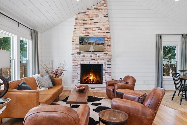703 E 15th St, Georgetown, TX 78626 - living area with vaulted ceiling, wood finished floors, wood ceiling, a fireplace, and wooden walls