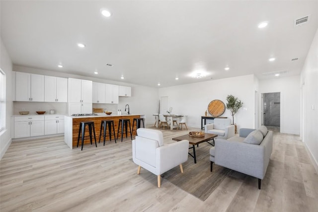 195 Bianca Cir, Del Valle, TX 78617 - living area with light wood-style flooring and recessed lighting