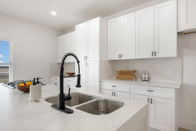 195 Bianca Cir, Del Valle, TX 78617 - kitchen with white cabinetry, light countertops, and recessed lighting