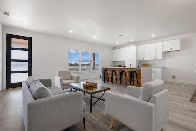195 Bianca Cir, Del Valle, TX 78617 - living room with light wood-style flooring and recessed lighting