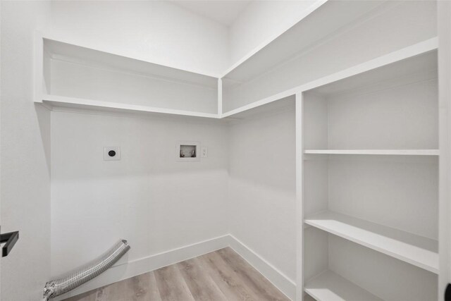 195 Bianca Cir, Del Valle, TX 78617 - laundry room featuring hookup for an electric dryer, washer hookup, and wood finished floors
