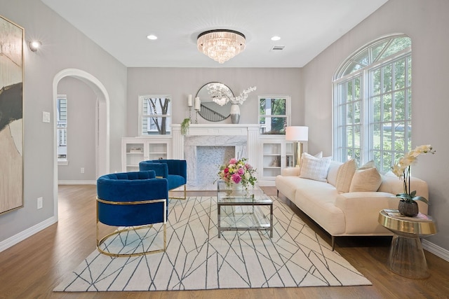 2110 Travis Heights Blvd, Austin, TX 78704 - living area featuring arched walkways, wood finished floors, a chandelier, baseboards, and recessed lighting