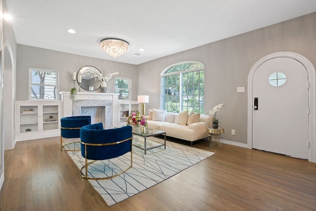 2110 Travis Heights Blvd, Austin, TX 78704 - living area featuring wood finished floors, arched walkways, a fireplace, a chandelier, and recessed lighting