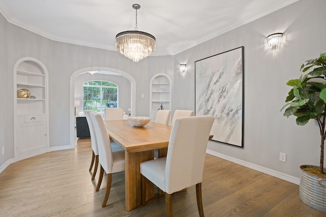 2110 Travis Heights Blvd, Austin, TX 78704 - dining area with built in features, a chandelier, baseboards, wood finished floors, and ornamental molding