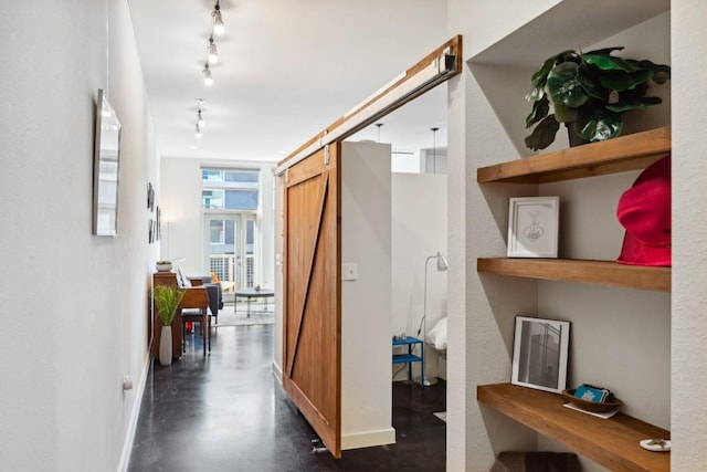 1601 E Cesar Chavez St Unit 202, Austin, TX 78702 - hall with a barn door, track lighting, and concrete flooring
