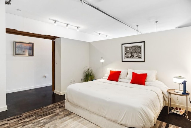 1601 E Cesar Chavez St Unit 202, Austin, TX 78702 - bedroom featuring baseboards and wood finished floors