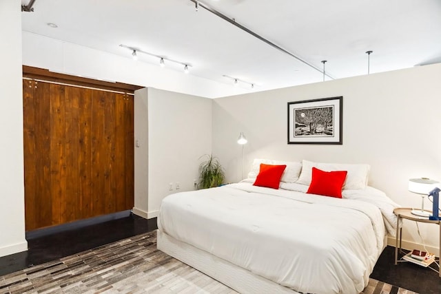 1601 E Cesar Chavez St Unit 202, Austin, TX 78702 - bedroom featuring wood finished floors and baseboards