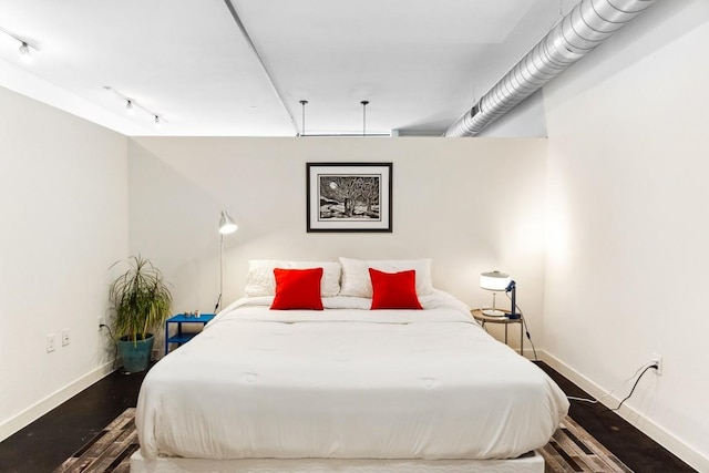 1601 E Cesar Chavez St Unit 202, Austin, TX 78702 - bedroom featuring baseboards and track lighting