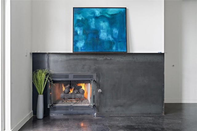 1601 E Cesar Chavez St Unit 202, Austin, TX 78702 - details with concrete floors, baseboards, and a lit fireplace