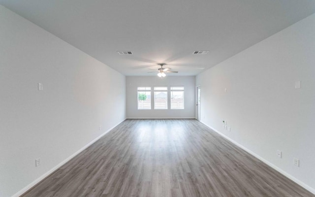 201 Lt Rusty Dr, Jarrell, TX 76537 - empty room featuring wood finished floors, ceiling fan, and baseboards