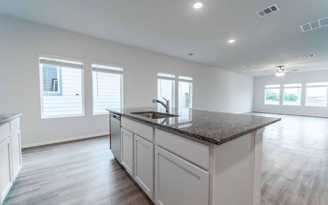 201 Lt Rusty Dr, Jarrell, TX 76537 - kitchen featuring stainless steel dishwasher, light wood finished floors, dark stone countertops, and recessed lighting