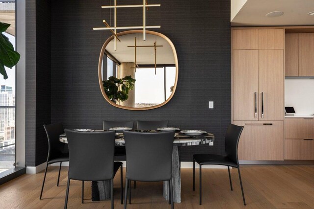 44 E Ave Unit 2601, Austin, TX 78701 - dining space with light wood-style flooring and baseboards