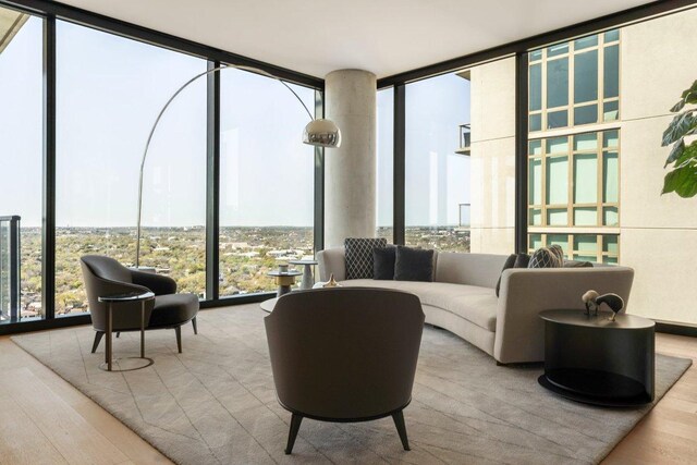 44 E Ave Unit 2601, Austin, TX 78701 - living room featuring a wall of windows and wood finished floors