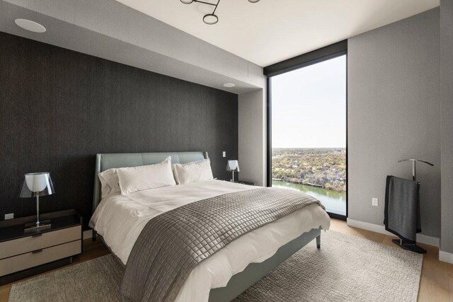 44 E Ave Unit 2601, Austin, TX 78701 - bedroom featuring floor to ceiling windows and wood finished floors