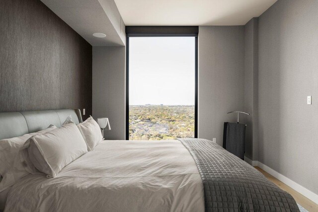 44 E Ave Unit 2601, Austin, TX 78701 - bedroom featuring wood finished floors and baseboards