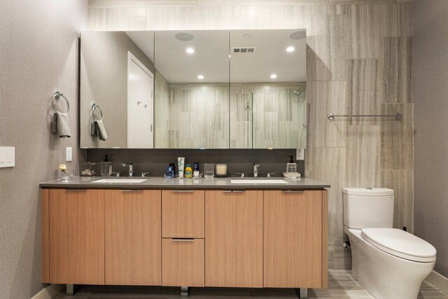 44 E Ave Unit 2601, Austin, TX 78701 - bathroom featuring double vanity and toilet