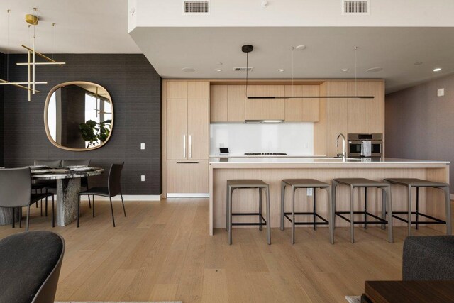 44 E Ave Unit 2601, Austin, TX 78701 - kitchen featuring light brown cabinetry, modern cabinets, stainless steel oven, a sink, and recessed lighting