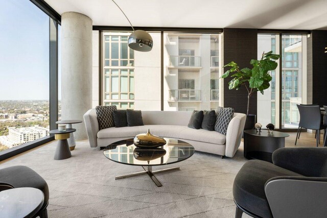 44 E Ave Unit 2601, Austin, TX 78701 - living room featuring expansive windows, carpet floors, and decorative columns