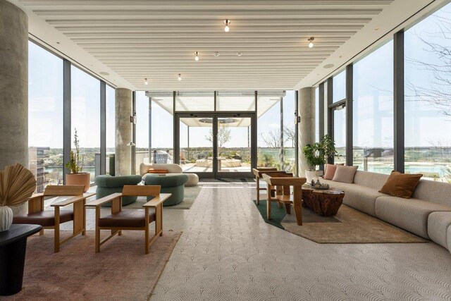 44 E Ave Unit 2601, Austin, TX 78701 - sunroom / solarium featuring floor to ceiling windows and carpet flooring