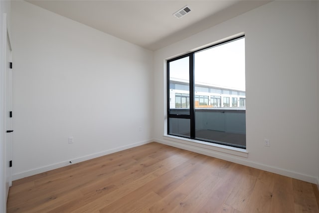 2209 S 1st St Unit 407, Austin, TX 78704 - spare room featuring light wood finished floors and baseboards
