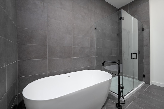 2209 S 1st St Unit 407, Austin, TX 78704 - full bath featuring a soaking tub, a shower stall, and tile patterned flooring
