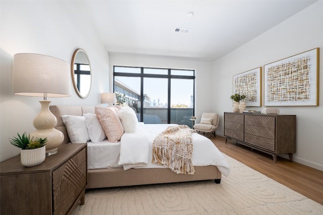 2209 S 1st St Unit 407, Austin, TX 78704 - bedroom featuring wood finished floors and access to exterior