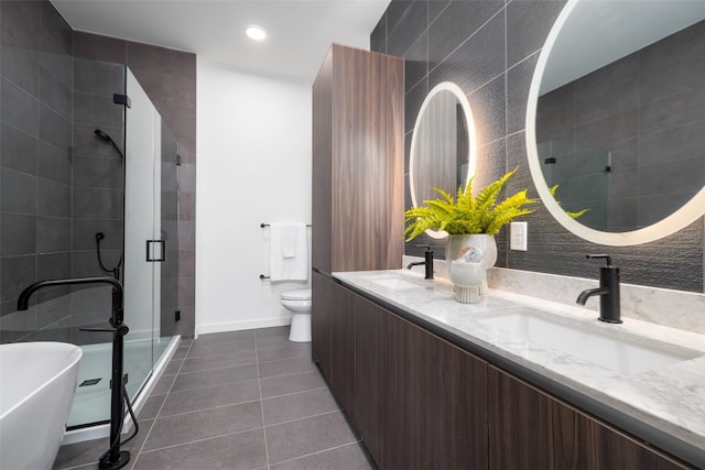 2209 S 1st St Unit 407, Austin, TX 78704 - bathroom with tile patterned flooring, double vanity, a stall shower, a freestanding tub, and recessed lighting