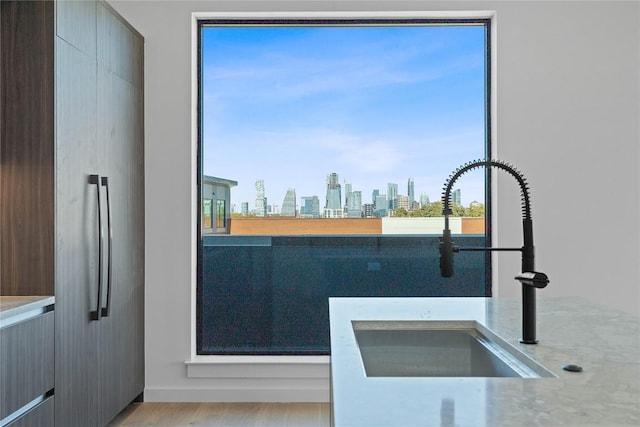 2209 S 1st St Unit 407, Austin, TX 78704 - kitchen with a skyline view, wood finished floors, and built in refrigerator