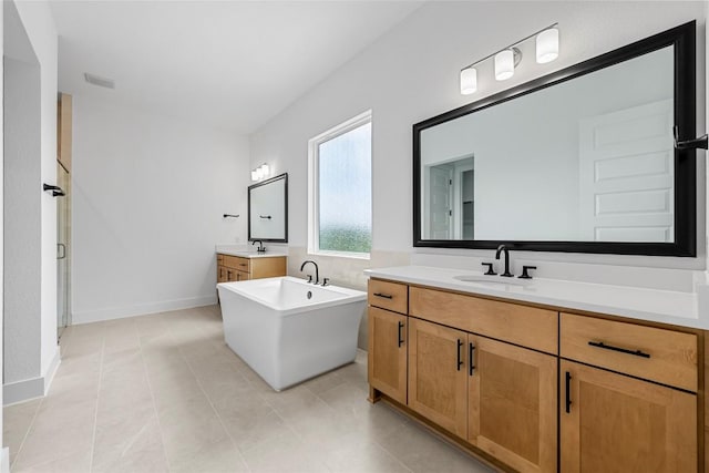 1304 Novara Trl, Leander, TX 78641 - bathroom with two vanities, a soaking tub, a stall shower, and tile patterned flooring