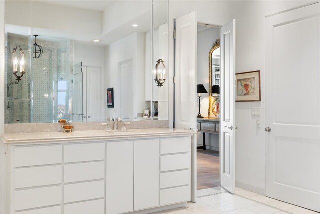 715 Cutlass, Lakeway, TX 78734 - full bathroom with tile patterned flooring, vanity, a stall shower, recessed lighting, and a chandelier