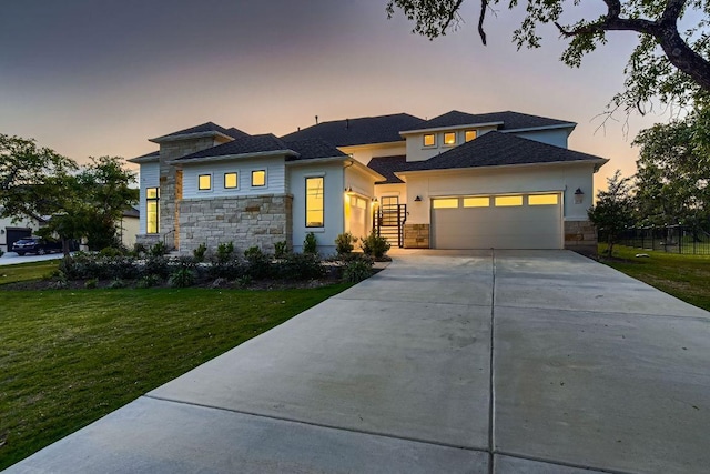 10928 Seawall Dr, Austin, TX 78737 - prairie-style house featuring stone siding, a garage, driveway, and a front lawn