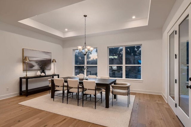 10928 Seawall Dr, Austin, TX 78737 - dining area with a raised ceiling, light wood-style flooring, a chandelier, and recessed lighting