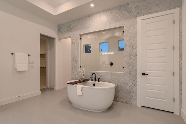 10928 Seawall Dr, Austin, TX 78737 - full bath featuring a soaking tub, a walk in closet, and tile walls