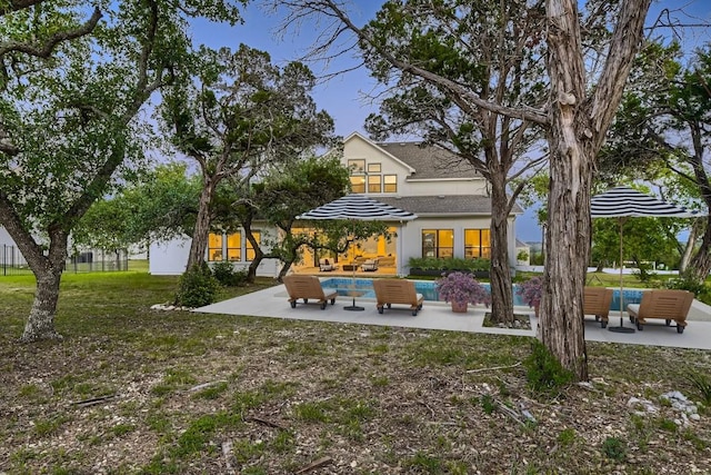 10928 Seawall Dr, Austin, TX 78737 - back of house with a patio area, an outdoor pool, stucco siding, an outdoor hangout area, and a lawn