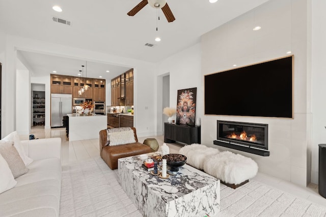 702 Serene Estates Dr, Austin, TX 78738 - living area with a ceiling fan, a glass covered fireplace, and recessed lighting