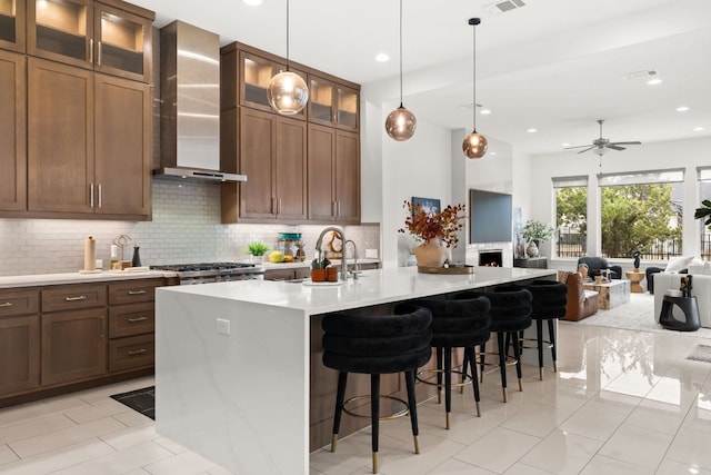 702 Serene Estates Dr, Austin, TX 78738 - kitchen with wall chimney range hood, open floor plan, backsplash, light countertops, and recessed lighting