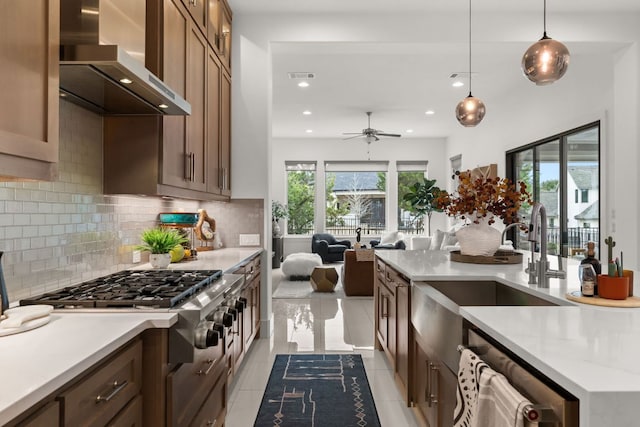 702 Serene Estates Dr, Austin, TX 78738 - kitchen with wall chimney exhaust hood, recessed lighting, pendant lighting, light countertops, and backsplash
