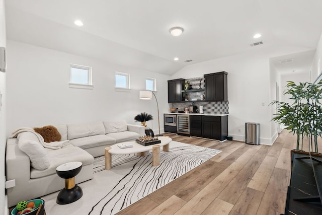 702 Serene Estates Dr, Austin, TX 78738 - living room featuring recessed lighting, lofted ceiling, light wood-type flooring, beverage cooler, and bar