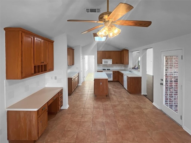 2804 Butler National Dr, Pflugerville, TX 78660 - kitchen with white appliances, ceiling fan, a sink, backsplash, and brown cabinetry