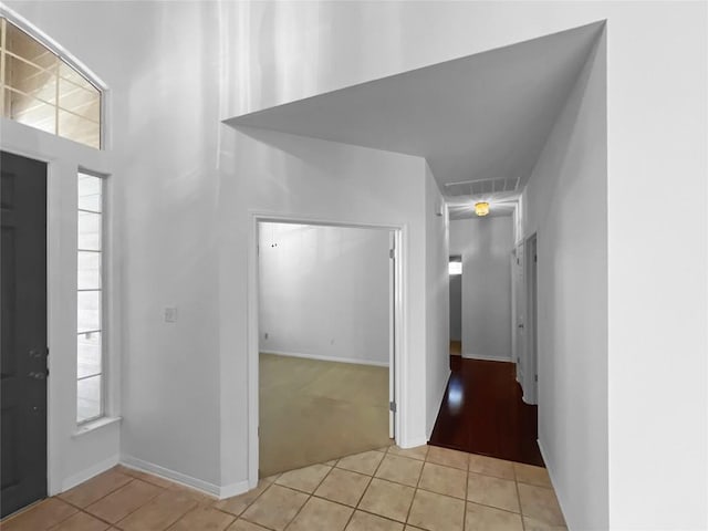 2804 Butler National Dr, Pflugerville, TX 78660 - entrance foyer with light tile patterned flooring, light carpet, and baseboards