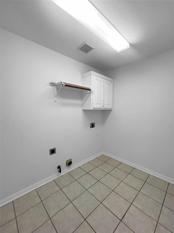 2804 Butler National Dr, Pflugerville, TX 78660 - laundry room with cabinet space, hookup for an electric dryer, hookup for a washing machine, hookup for a gas dryer, and baseboards