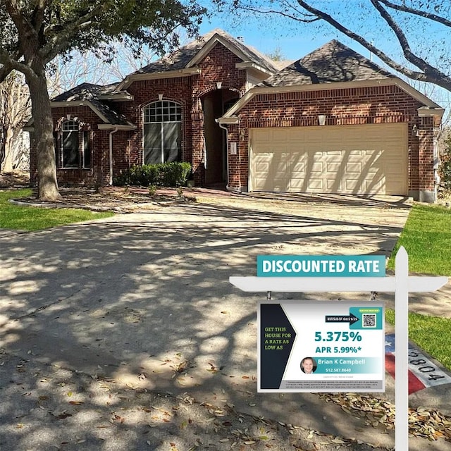 2804 Butler National Dr, Pflugerville, TX 78660 - view of front of property featuring brick siding, a garage, and driveway