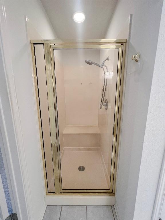 2804 Butler National Dr, Pflugerville, TX 78660 - full bath with a stall shower, tile patterned floors, and baseboards