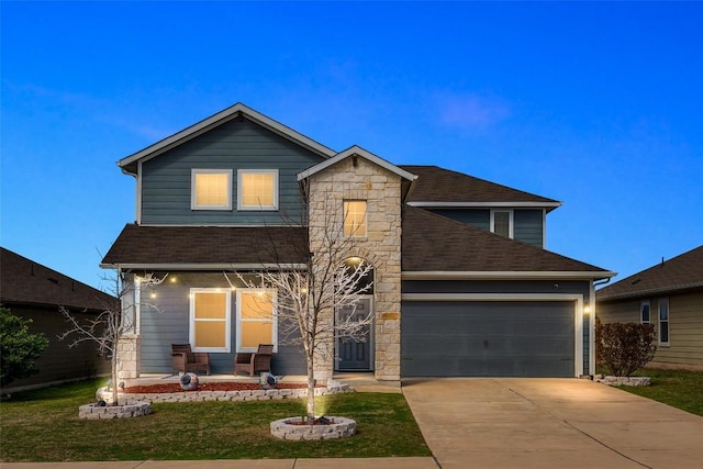 122 Denton Dr, Hutto, TX 78634 - view of front of house with a shingled roof, a front lawn, concrete driveway, a garage, and stone siding