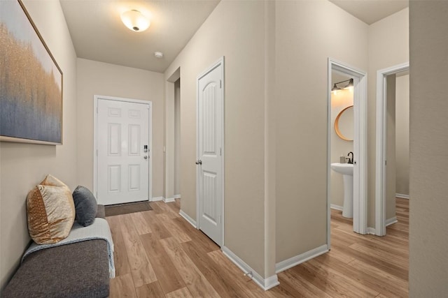 122 Denton Dr, Hutto, TX 78634 - hall with light wood-style flooring and baseboards