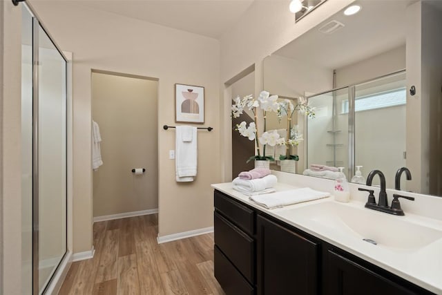 122 Denton Dr, Hutto, TX 78634 - full bath featuring vanity, wood finished floors, visible vents, and a stall shower