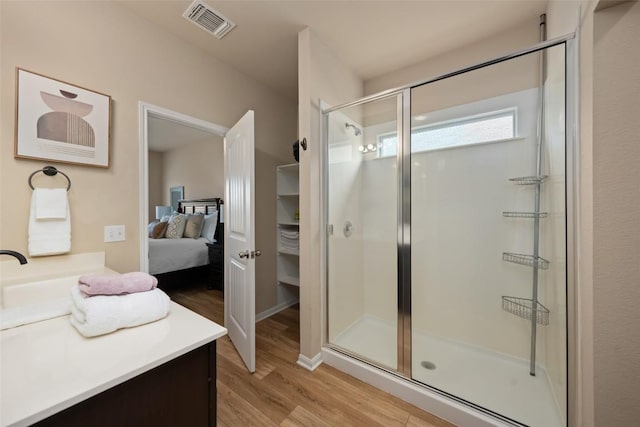 122 Denton Dr, Hutto, TX 78634 - full bath with vanity, wood finished floors, visible vents, ensuite bath, and a stall shower