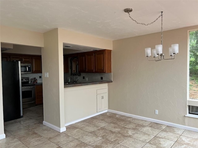 kitchen featuring a wealth of natural light, tasteful backsplash, a chandelier, and stainless steel appliances