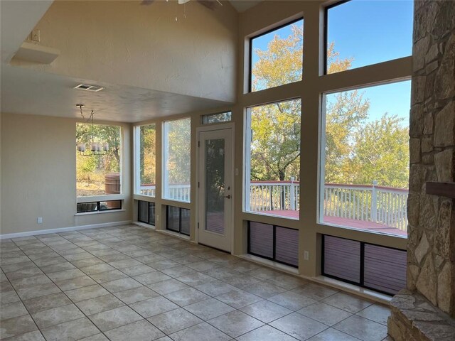 unfurnished sunroom featuring visible vents