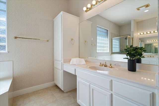 full bath with visible vents, a shower stall, vanity, baseboards, and tile patterned floors